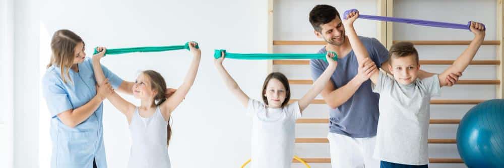 children exercising with the guidance of paediatric physiotherapists